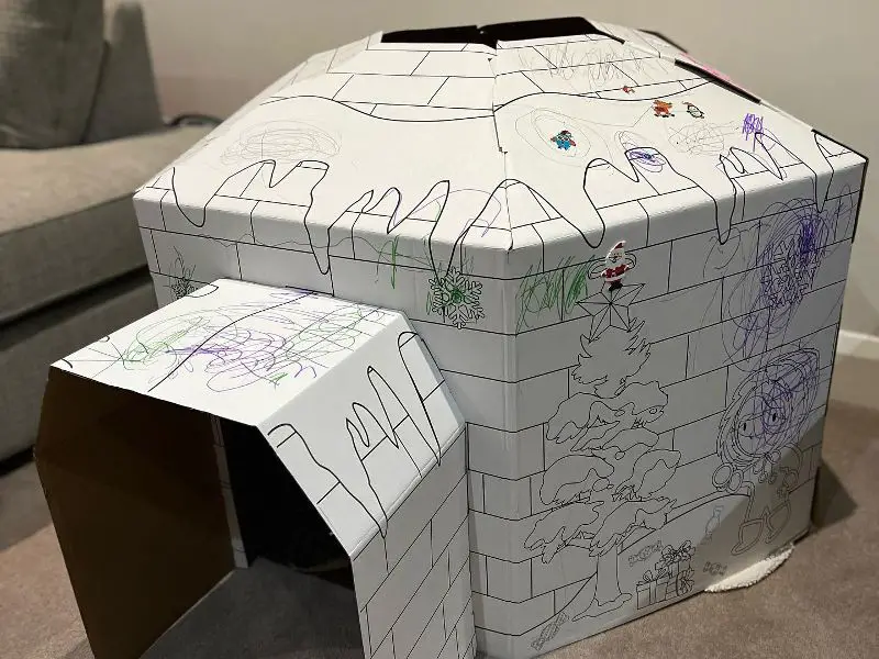 A child's drawing transforms into a cardboard playhouse.